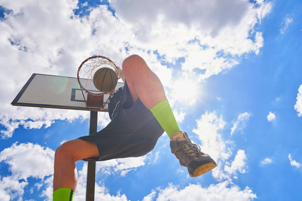 Basketball player in action flying high and scoring - Foto, Imagen