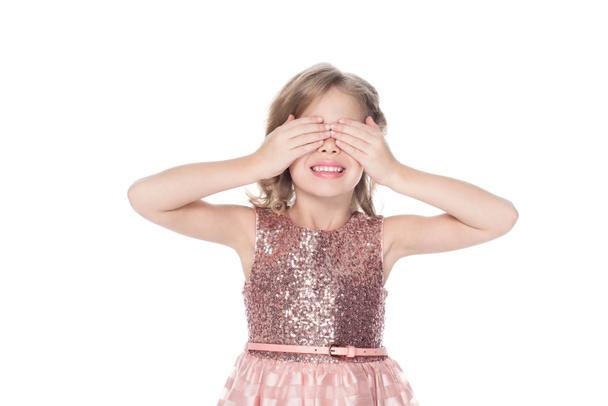 smiling kid in pink dress closing eyes, isolated on white  - Photo, Image