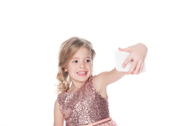 happy kid taking selfie on smartphone, isolated on white - 写真・画像