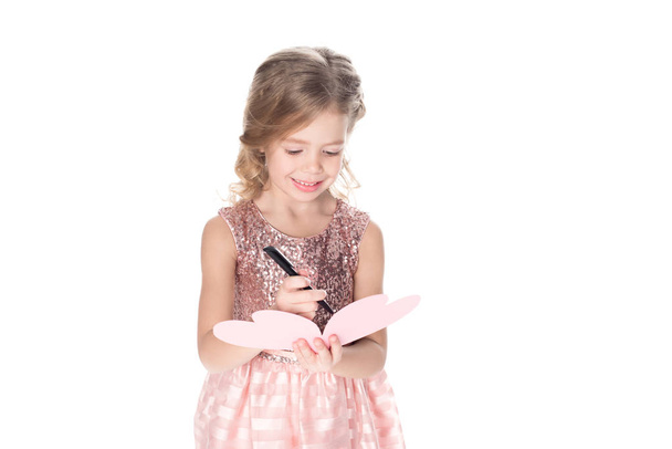 adorable child writing valentines greeting card, isolated on white - Zdjęcie, obraz
