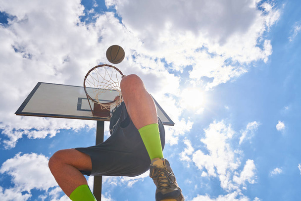 Basketball player in action flying high and scoring - Φωτογραφία, εικόνα