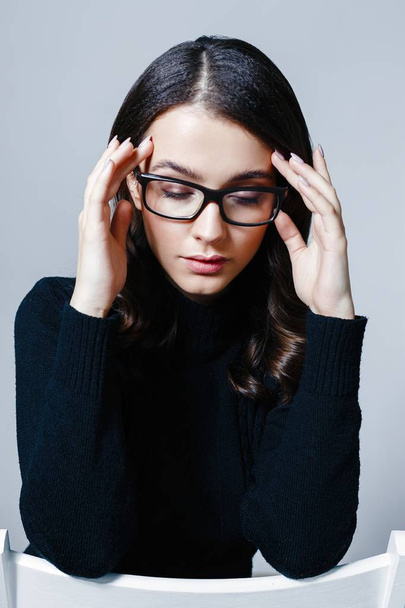Portrait of pretty young brunette woman in stylish eyeglasses posing in studio - Photo, Image