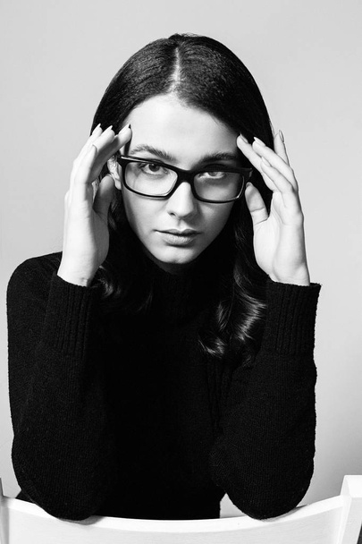 Portrait of pretty young brunette woman in stylish eyeglasses posing in studio - Fotografie, Obrázek