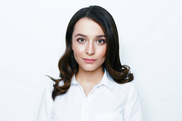 Pretty young brunette woman posing against white studio background  - Fotografie, Obrázek