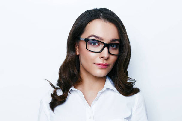 Portrait of pretty young brunette woman in stylish eyeglasses posing in studio - Φωτογραφία, εικόνα
