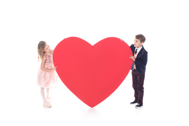 adorable little kids holding big red heart symbol isolated on white - Photo, Image