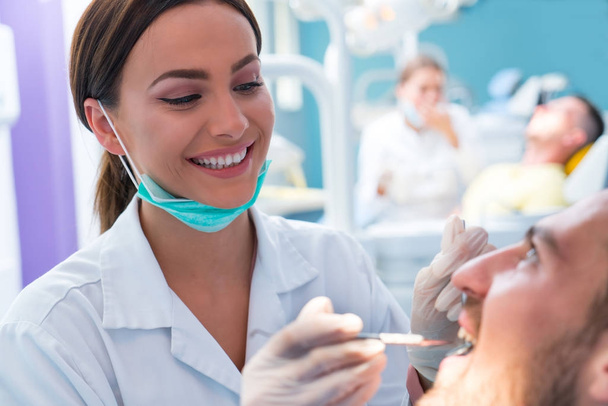 Doctor talking with her patient. Dentist concept - Photo, Image