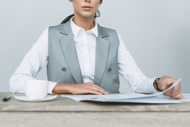 cropped image of businesswoman reading newspaper isolated on gray - Foto, Bild