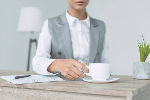 cropped image of businesswoman taking cup isolated on gray - Фото, зображення