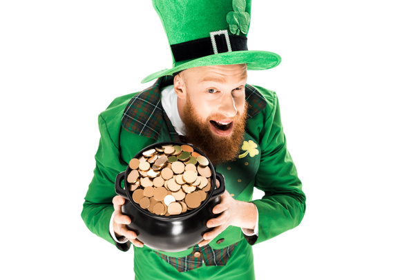 excited leprechaun in green suit and hat holding pot of gold, isolated on white  - Fotografie, Obrázek