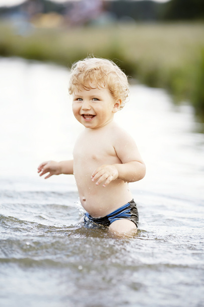 little funny boy playing in water - Foto, immagini