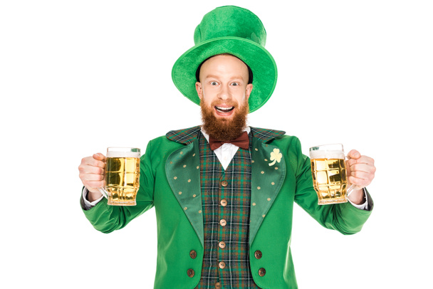 smiling leprechaun celebrating st patricks day with glasses of beer, isolated on white - Фото, изображение