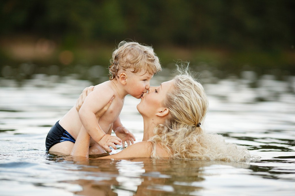 beautiful young mother with son in water - Foto, Imagem