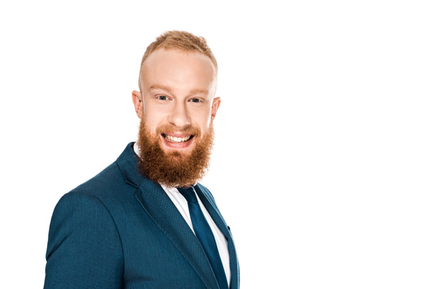 portrait of handsome bearded young businessman smiling at camera isolated on white - Foto, immagini