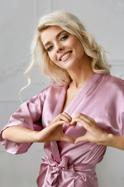 Love. Beautiful Female Model Showing Heart With Hands. - Foto, immagini