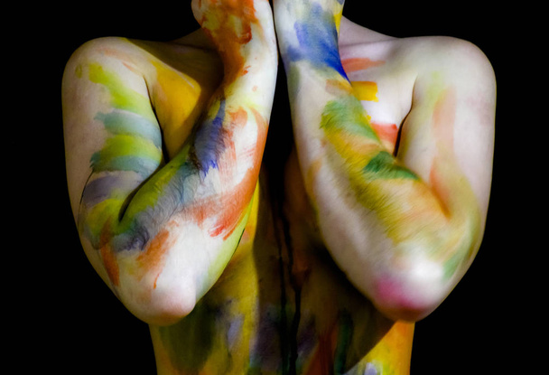 Body art. Drawing on the body. Beautiful girl with painted body watercolors. A white young girl painted the body with paint - Foto, Imagen