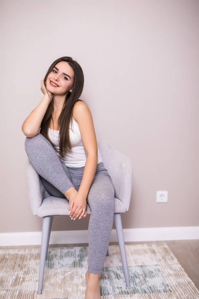 Relaxing woman sitting comfortable in sofa chair smiling happy looking at camera. - Foto, immagini