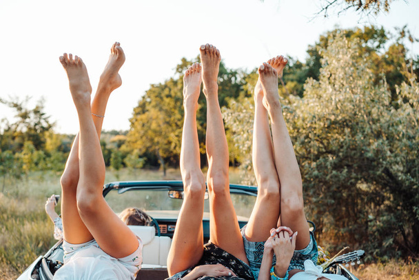Three girls are lying on the trunk - Photo, Image