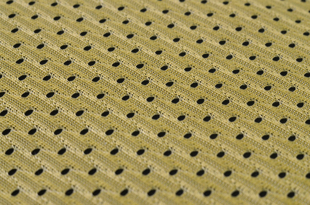 Hintergrundbild einer Textur aus einem gelben Jersey aus Polyester-Nylon. Makroaufnahme mit geringer Schärfentiefe - Foto, Bild