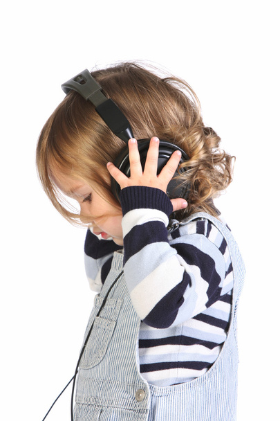 Beauty a little girl listening music - Foto, afbeelding