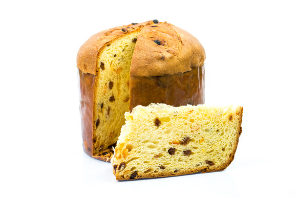 Classic panettone with dried fruit ,traditional Italian Christmas cake on white background. In front a sliced part of cake. - Photo, Image