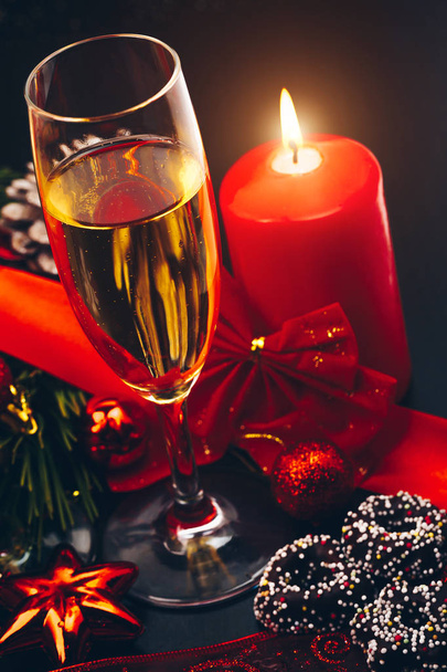 Christmas or New Year. Champagne in glasses with candles, panettone and gift with red satin bow. Copy-space. Holiday Concept - Fotoğraf, Görsel