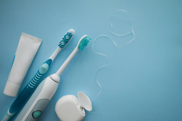 A set of sonic toothbrush, dental floss and toothpaste. - Photo, Image