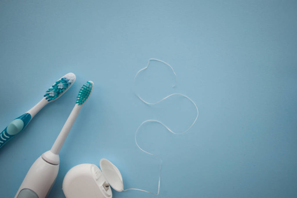 A set of sonic toothbrush, dental floss and classic toothbrush - Photo, Image