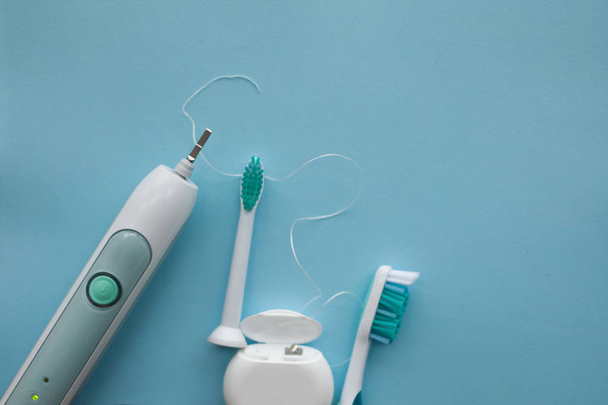 A set of sonic toothbrush, dental floss and classic toothbrush - Photo, image
