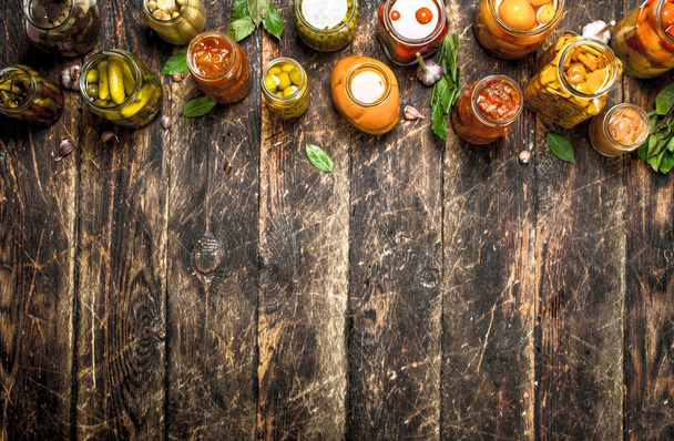 Different preserved vegetables from vegetables and mushrooms in glass jars. - Foto, Imagen