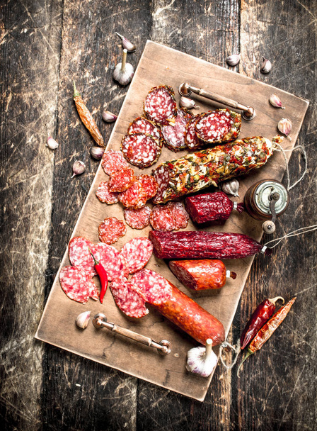 Different kinds of salami on the boards. - Foto, immagini
