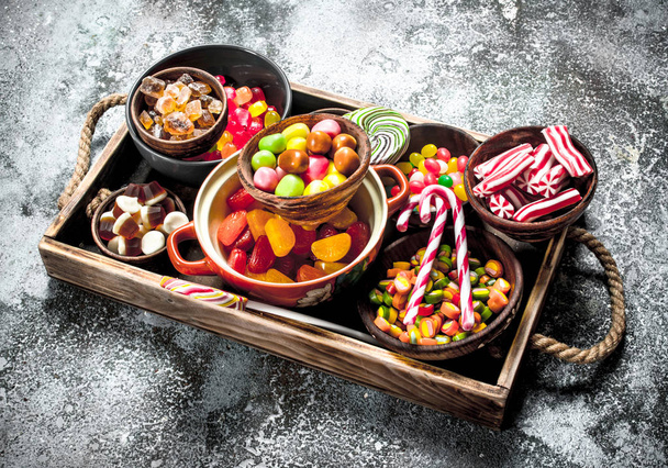 sweets candy, candied fruits with marshmallow and jelly on a wooden tray. - Foto, Imagem