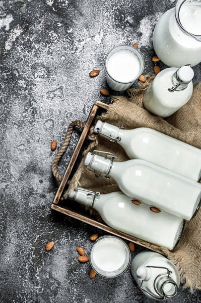 Milk background. Fresh milk in a wooden tray. - Фото, зображення