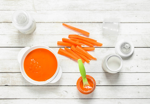 Baby food. Baby carrot puree with milk in a bottle. - Photo, Image