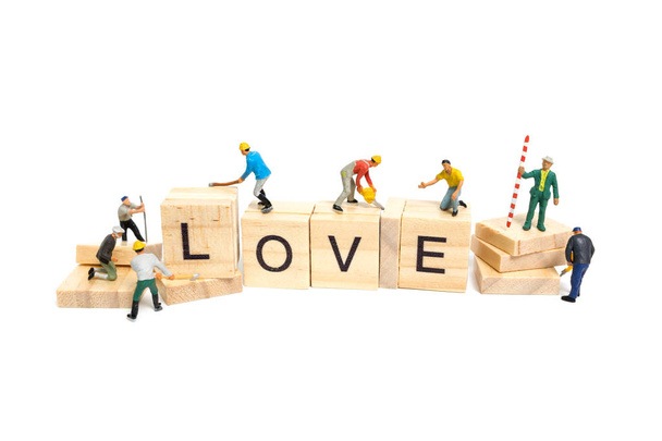 Miniature people: Worker team building word "Love
 "  - Фото, изображение
