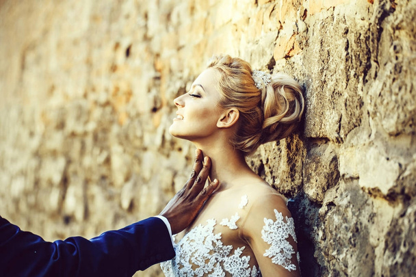 Pretty girl or cute bride with male hand on neck - Foto, Imagem