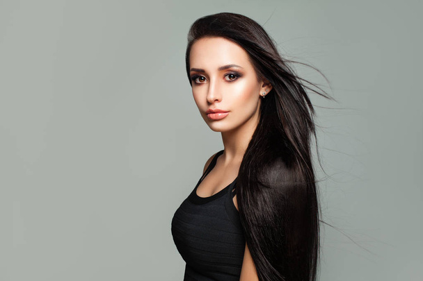 Young Brunette Woman with Shiny Blowing Hair and Natural Makeup  - Photo, Image