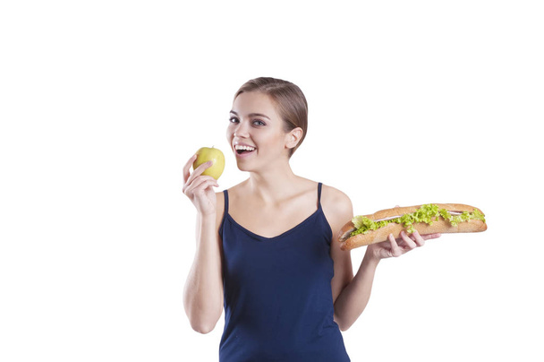 σπορ κορίτσι με ένα σάντουιτς και ένα μήλο που απομονώνονται - Φωτογραφία, εικόνα