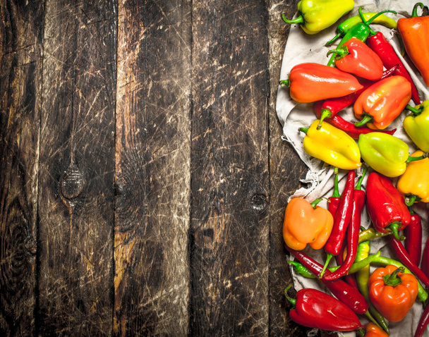 Fresh colorful peppers. On wooden background. - Fotoğraf, Görsel