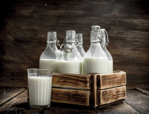 Bottles with fresh milk in a box. - Photo, image
