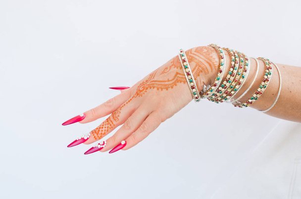 nails decorated with brilliant and hand with henna tattoos - Foto, imagen