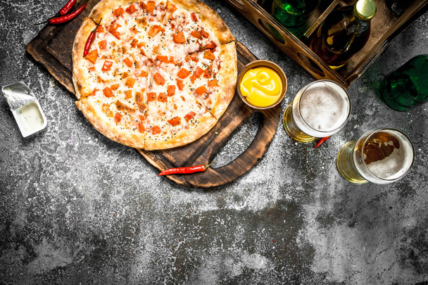 Pizza margarita with sauce and fresh beer. - Photo, image