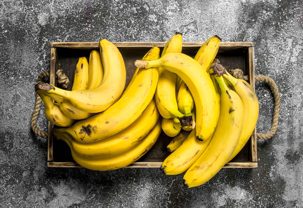 Fresh bananas on a wooden tray. - Photo, Image