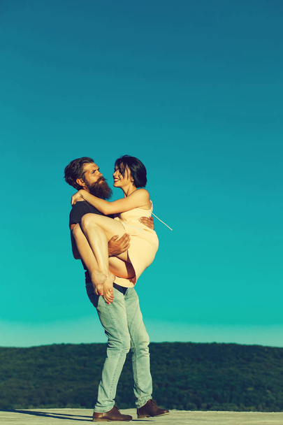young couple on blue sky - Zdjęcie, obraz