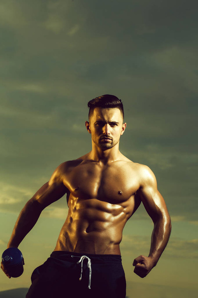 Wet muscular man with water bottle - Photo, image
