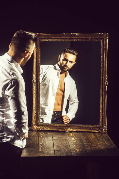 muscular macho man with sexy athlete body near vintage mirror - Фото, зображення