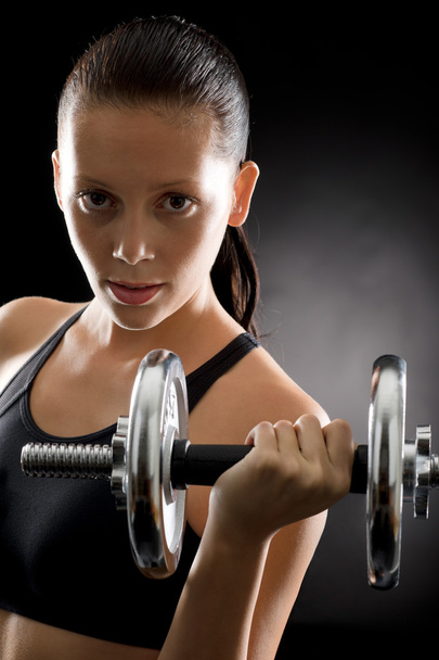 Active woman exercise weights on black background - Valokuva, kuva