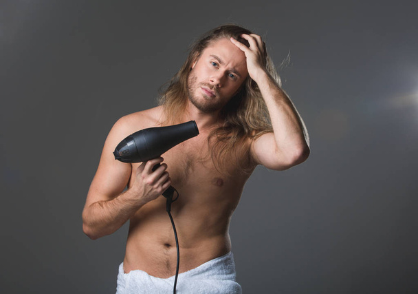 Tranquil man taking care about hair - Foto, Imagem