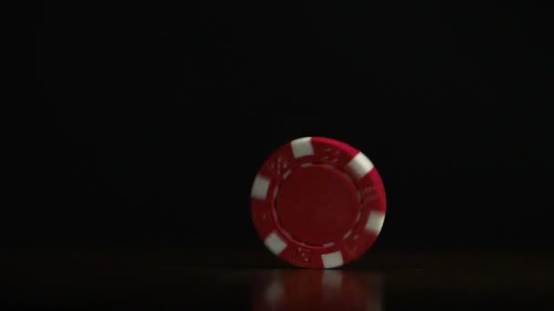 Poker chip spinning on the table. Casino theme. Poker game, poker chips on table, on black background - Footage, Video