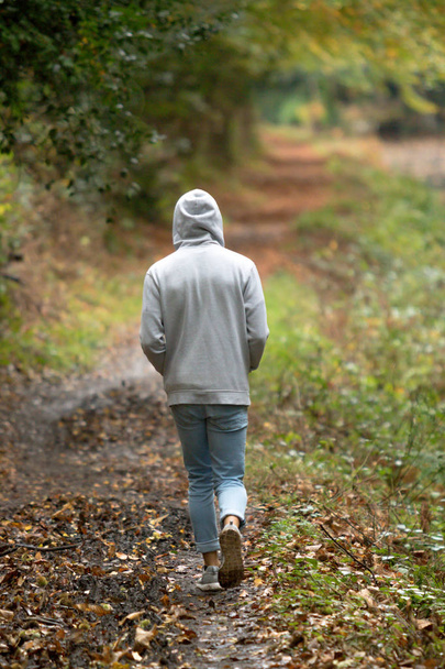 Teenage boy walking alone on an atumn day - Foto, Imagen